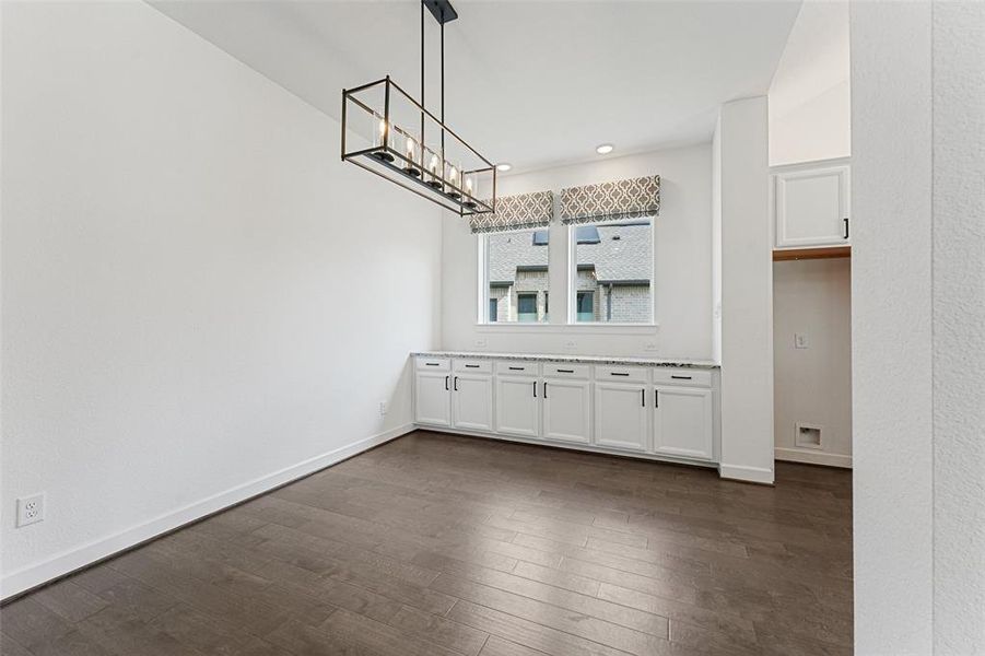 Step into this charming dining room, where elegance meets practicality! A stylish dry bar with ample storage is perfect for entertaining, making it easy to showcase your favorite beverages and accessories.