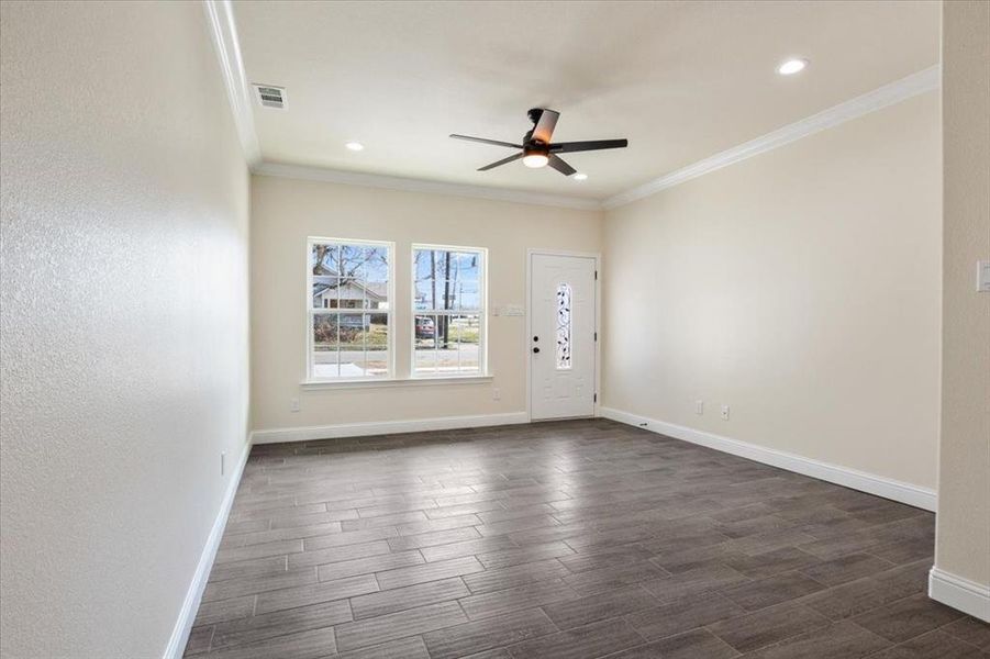 Empty room featuring ornamental molding and ceiling fan