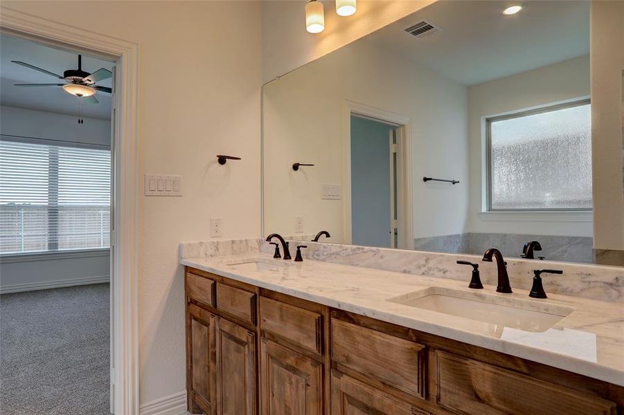 Bathroom with dual vanity and ceiling fan