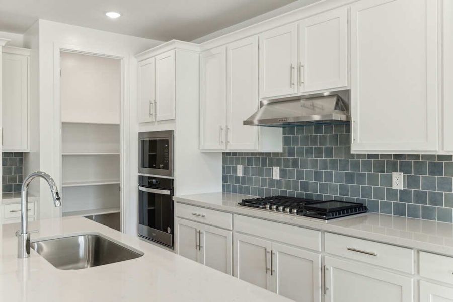 Kitchen & Great Room. Actual finishes may vary by community.