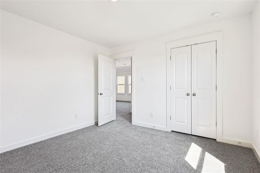 Unfurnished bedroom with a closet and carpet