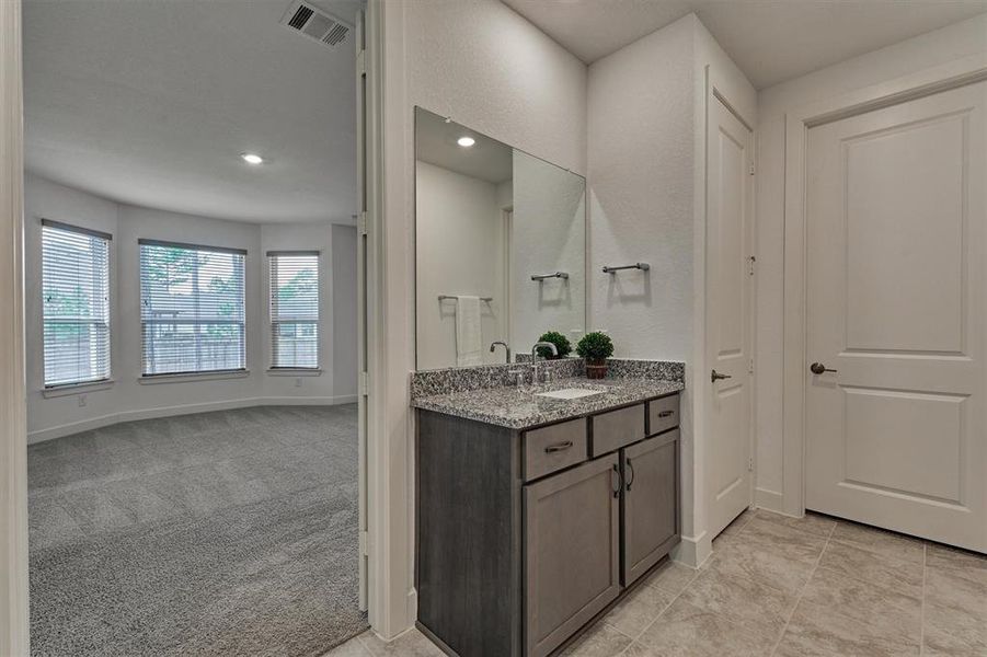 Another view to appreciate the elevated functionality in the primary bath, including linen storage.