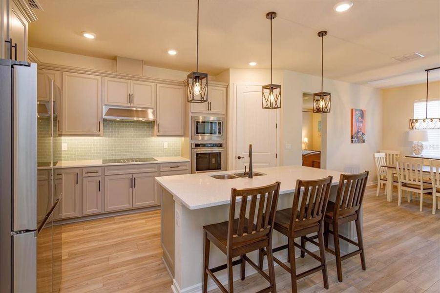 Beautiful backsplash, built in Kitchen Aid: oven, microwave, cooktop, dishwasher, Samsung Refrigerator