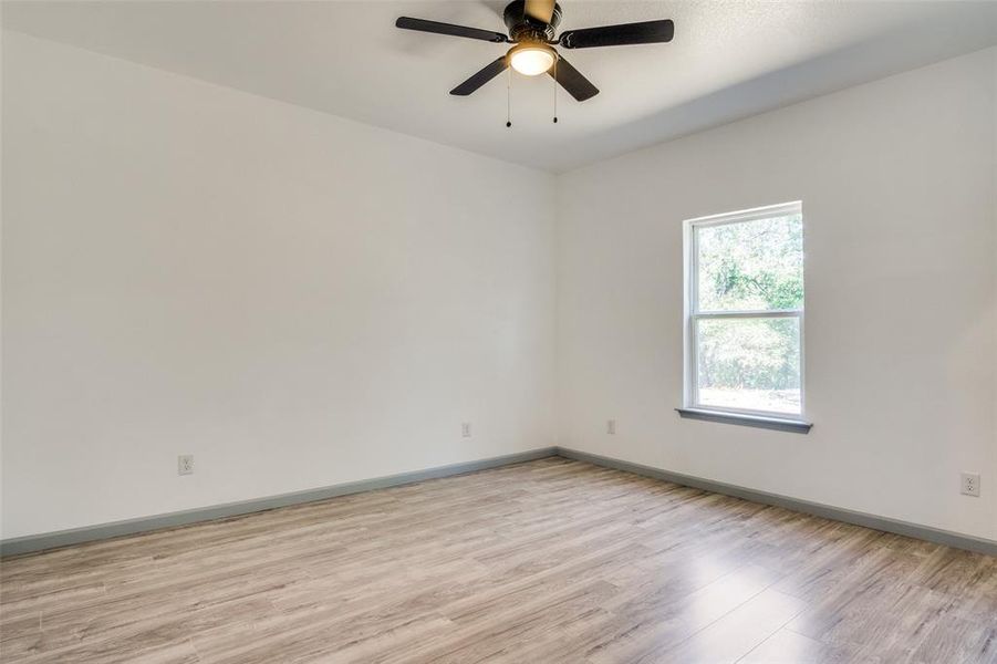 Spare room with light hardwood / wood-style floors and ceiling fan