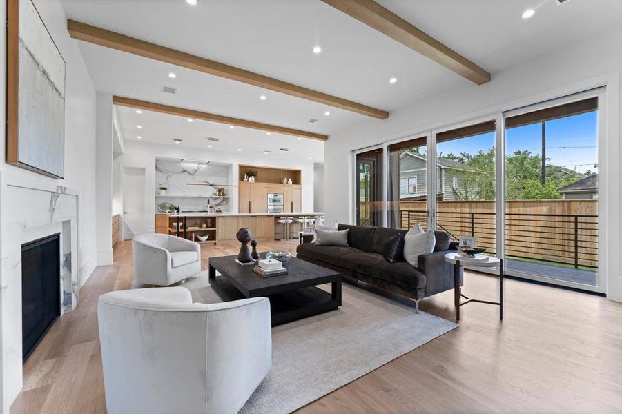 Experience a seamless transition between indoor and outdoor living through the floor to ceiling sliding doors connecting you to the covered back patio and pool ready yard space.