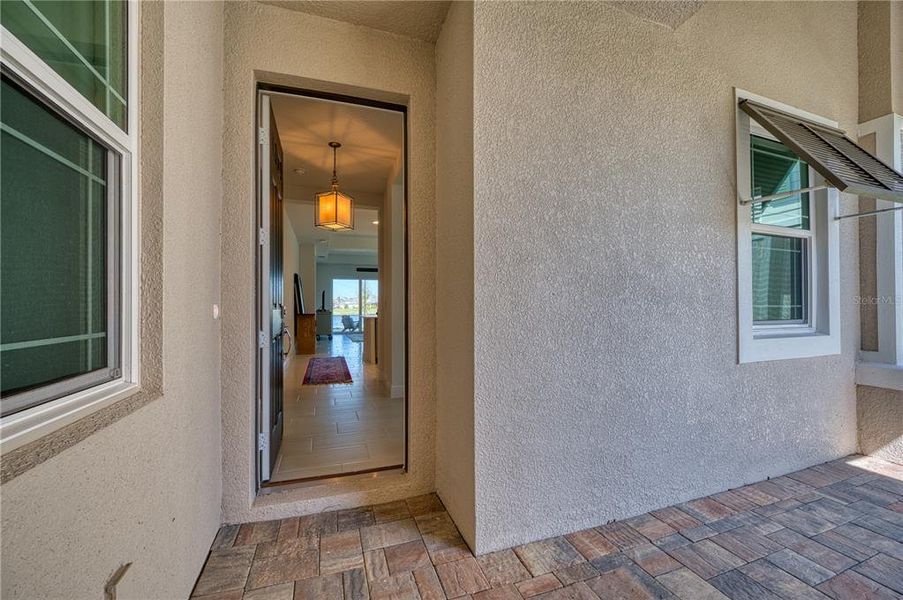 Covered entry porch between the garage and the villa.