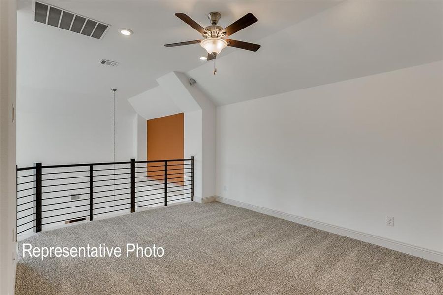 Bonus room with lofted ceiling, carpet floors, and ceiling fan