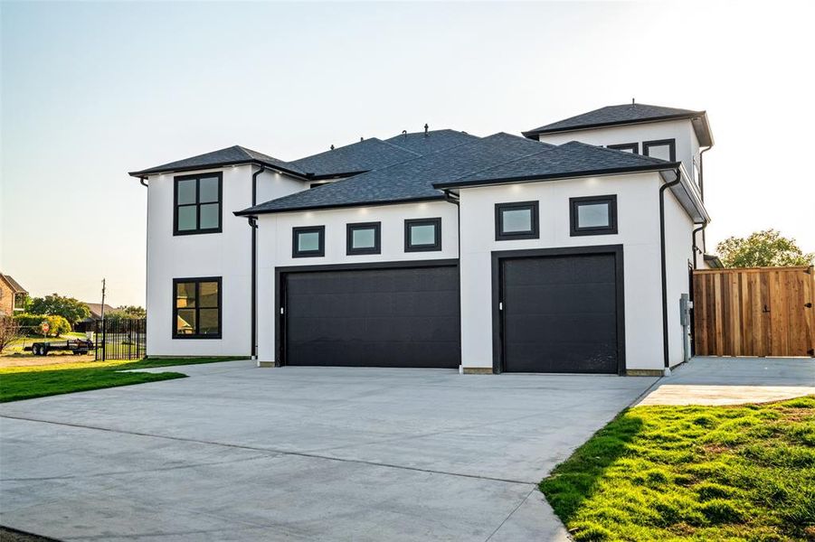 View of front of house with a garage and a front yard