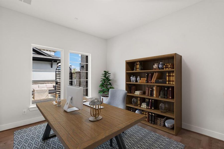 The home office features two windows, hard wood flooring, and large baseboards, creating a bright and stylish workspace. *Virtually Staged*