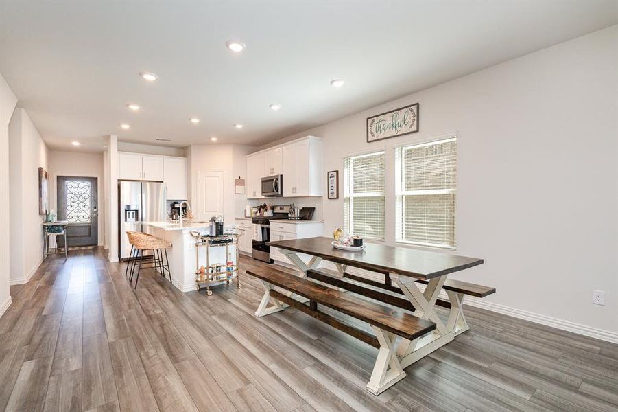 Dining room with sink and light hardwood / wood-style flooring