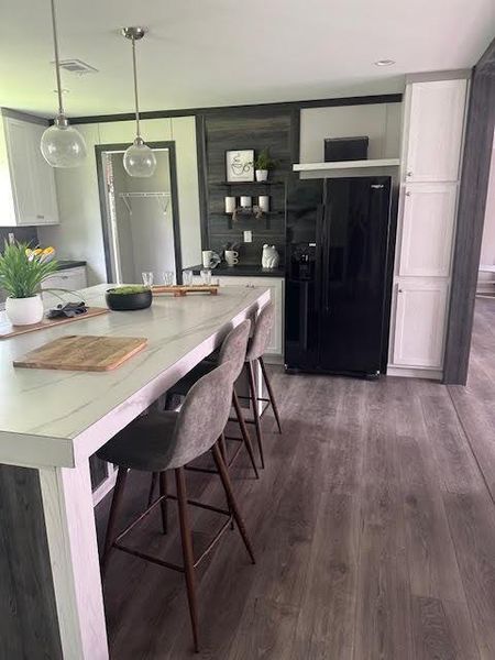 Dining space with dark hardwood / wood-style floors