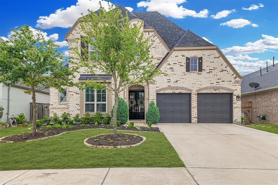 Stunning Highland built home with a beautifully landscaped front yard.