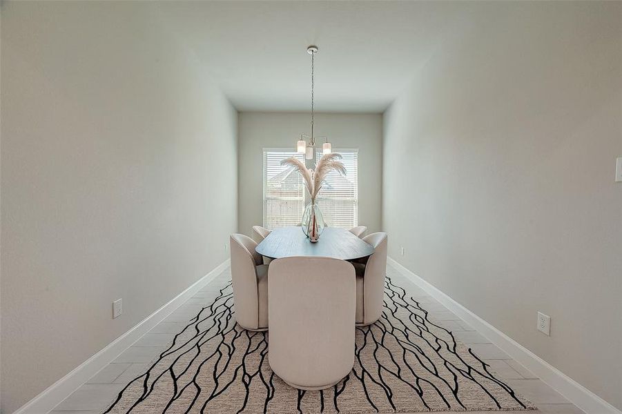 This dining room is bathed in naturallight streaming through expansivewindows.