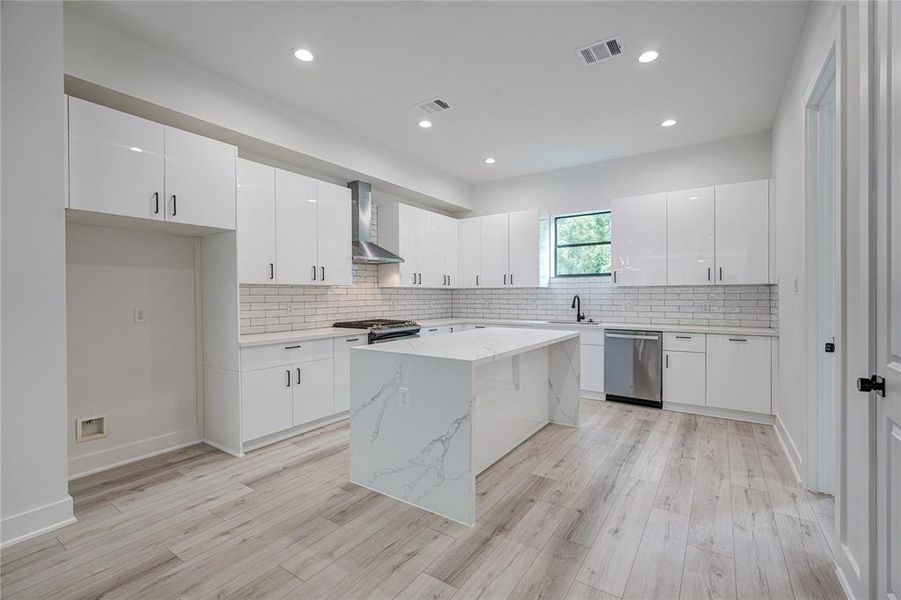 Large kitchen with a lot of cabinet storage space and room on the countertop