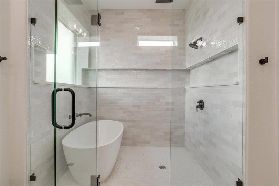 Bathroom featuring plenty of natural light and independent shower and bath