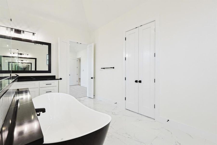 Bathroom with vanity and a bathing tub