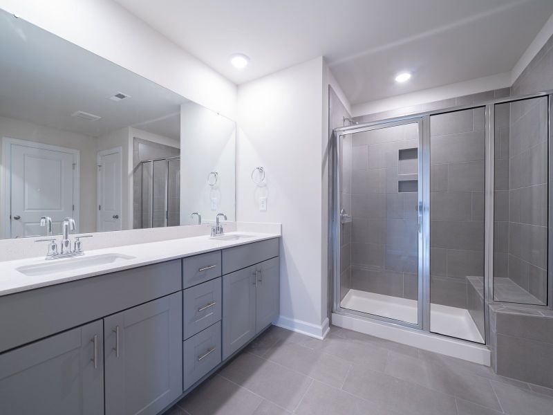 The primary bath offers dual vanity sinks.