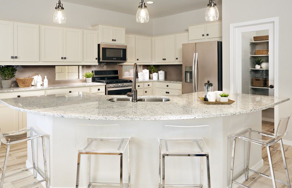 Gorgeous kitchen with curved island and tasteful p