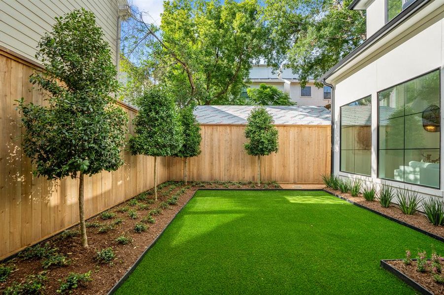 Turf means low maintenance and a lock-and-leave lifestyle. Beautiful trees and shrubs planted around the perimeter of this backyard.