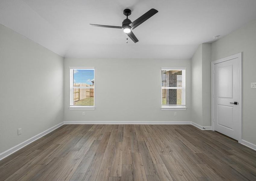 Master bedroom with plank flooring and a ceiling fan