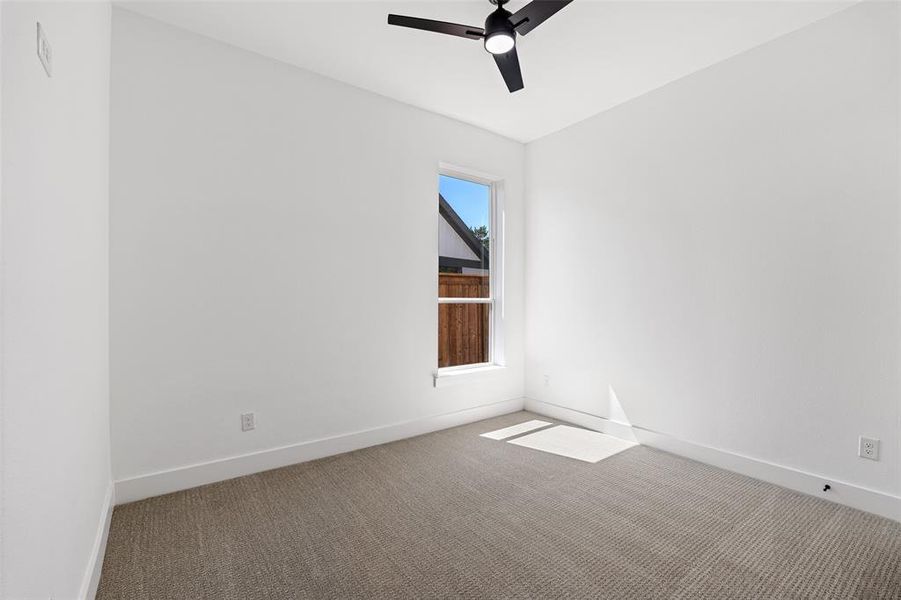 Spare room featuring ceiling fan and carpet flooring