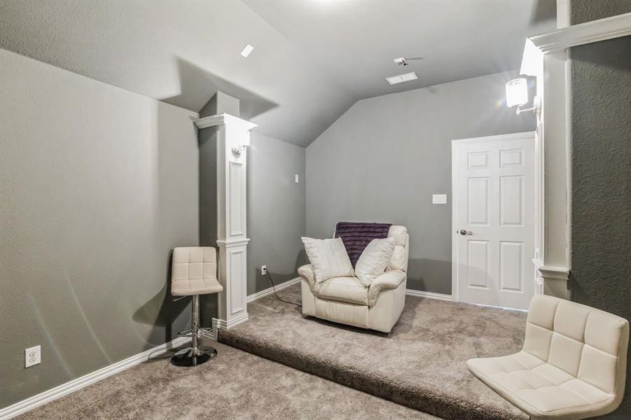 Living area featuring carpet floors and lofted ceiling