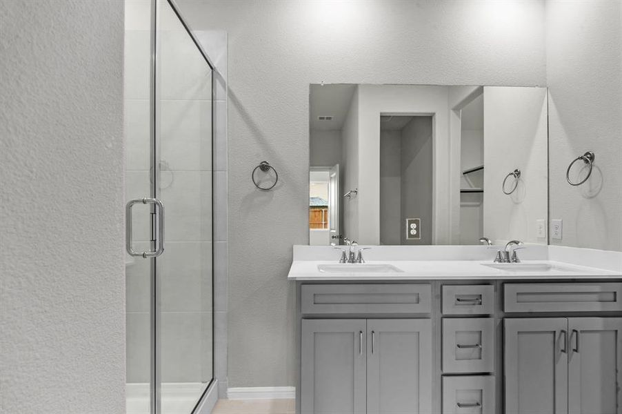 Bathroom with vanity and a shower with shower door