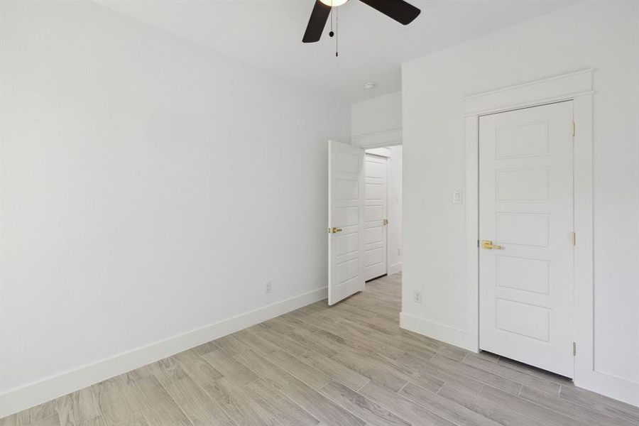 Unfurnished bedroom with light wood-type flooring and ceiling fan