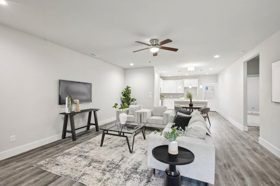 Living room featuring a spacious open floor plan and a ceiling fan