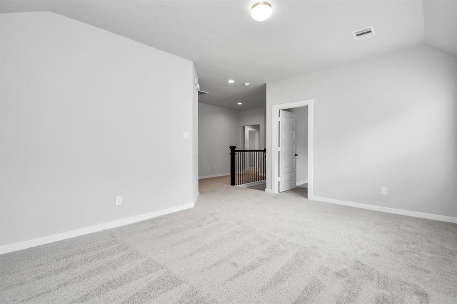 Come upstairs and relish a day of relaxation in this loft area! Ideal as an additional living space or game room, it boasts plush carpeting, high ceilings, custom paint, and windows that flood the area with abundant natural light. Sample photo of completed home with similar floor plan. Actual colors and selections may vary.