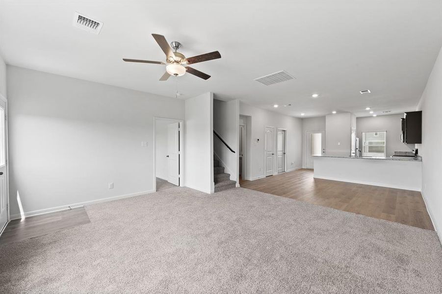 Living room with ceiling fan and carpet flooring
