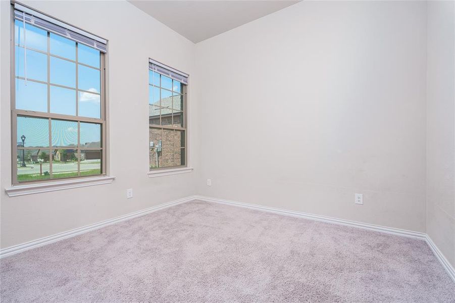 Empty room with a healthy amount of sunlight and carpet floors