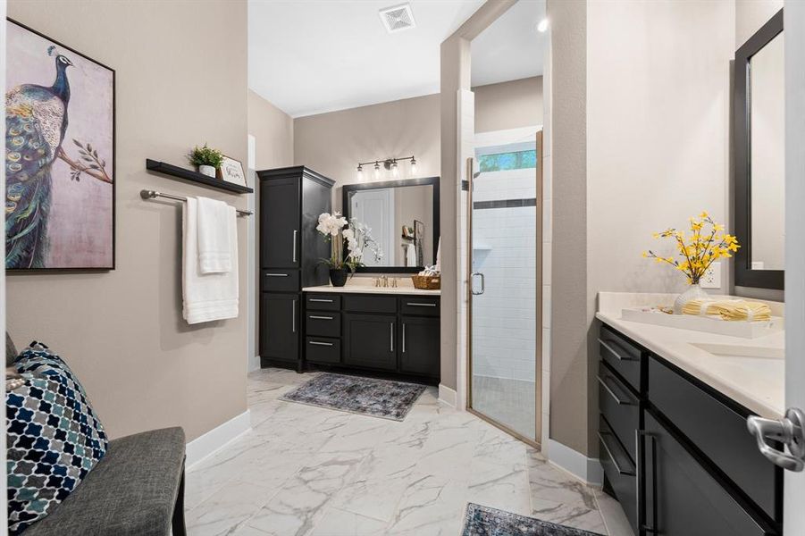 Step into your personal oasis in this primary bathroom, designed for both luxury and functionality. Enjoy the spaciousness of a large walk-in shower, perfect for refreshing mornings or relaxing evenings. With separate vanity areas, you'll find convenience and privacy for your daily routines, making this bathroom a true retreat.