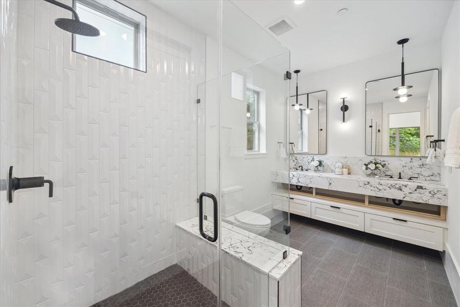 A private en-suite bathroom for the mm-in-law suite offers the ultimate in convenience and privacy, with sleek fixtures and stylish finishes that exude sophistication. Dual vanities, walk-in shower and a large closet!