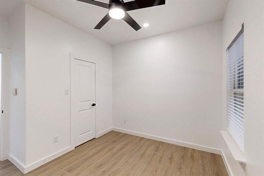 Spare room with ceiling fan and light hardwood / wood-style flooring