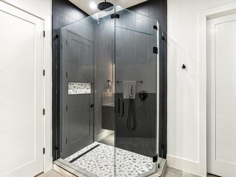 Bathroom with tile patterned flooring and a shower with door