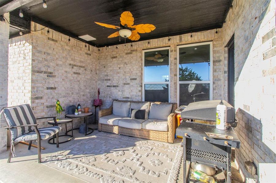 View of patio with outdoor lounge area and ceiling fan