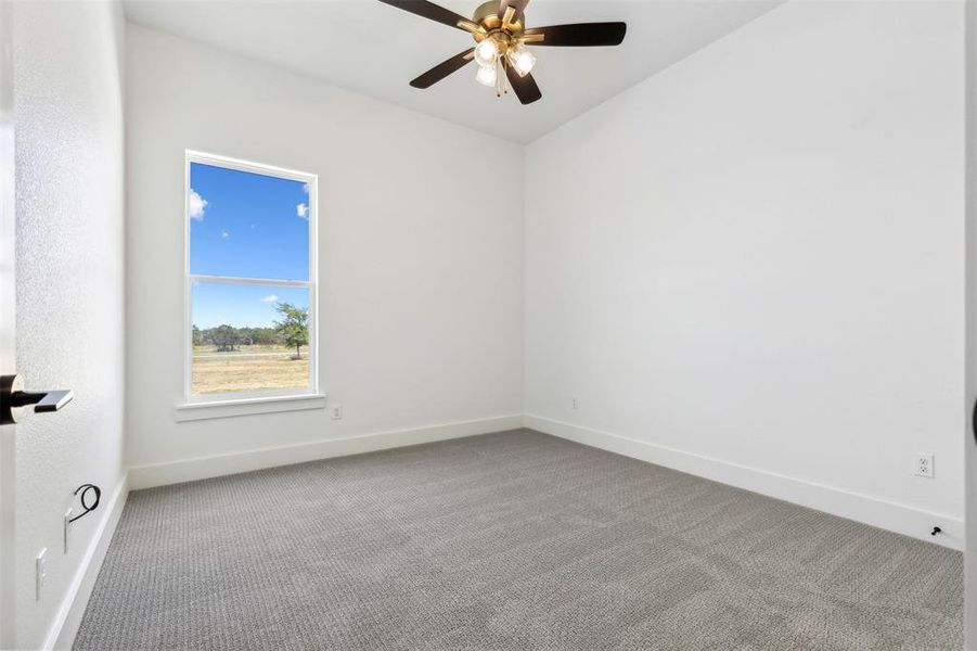 Empty room with carpet and ceiling fan