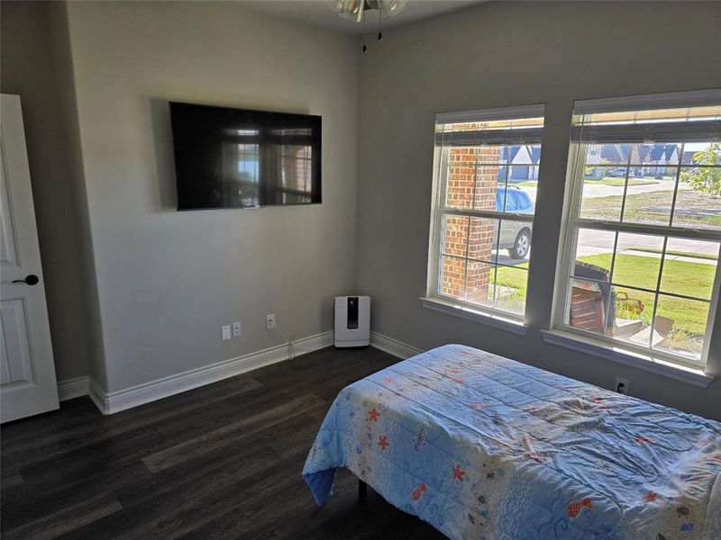 Bedroom with dark hardwood / wood-style floors