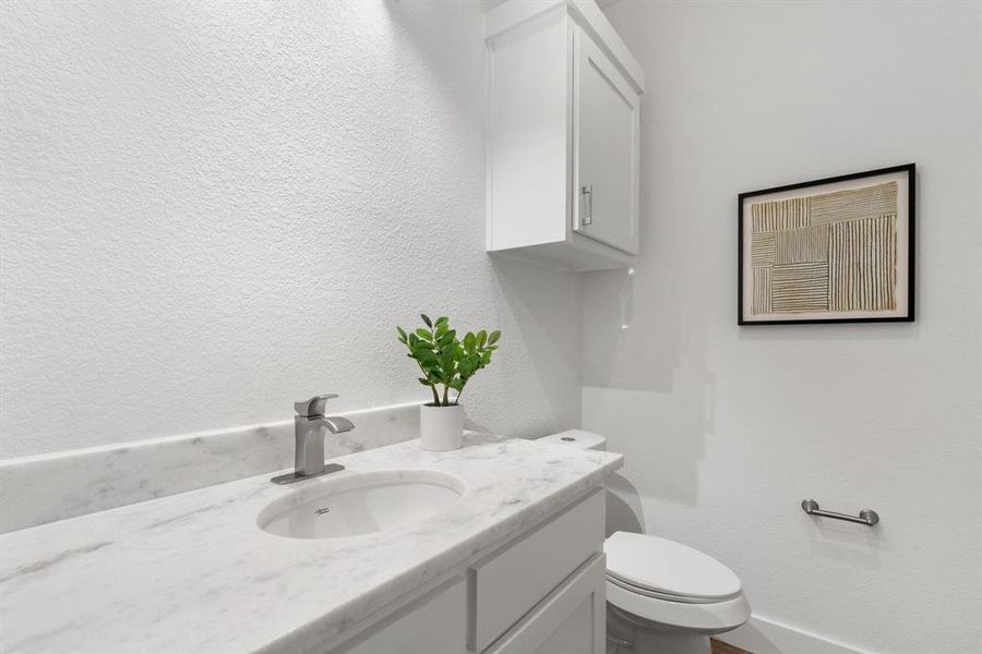 Bathroom featuring vanity and toilet