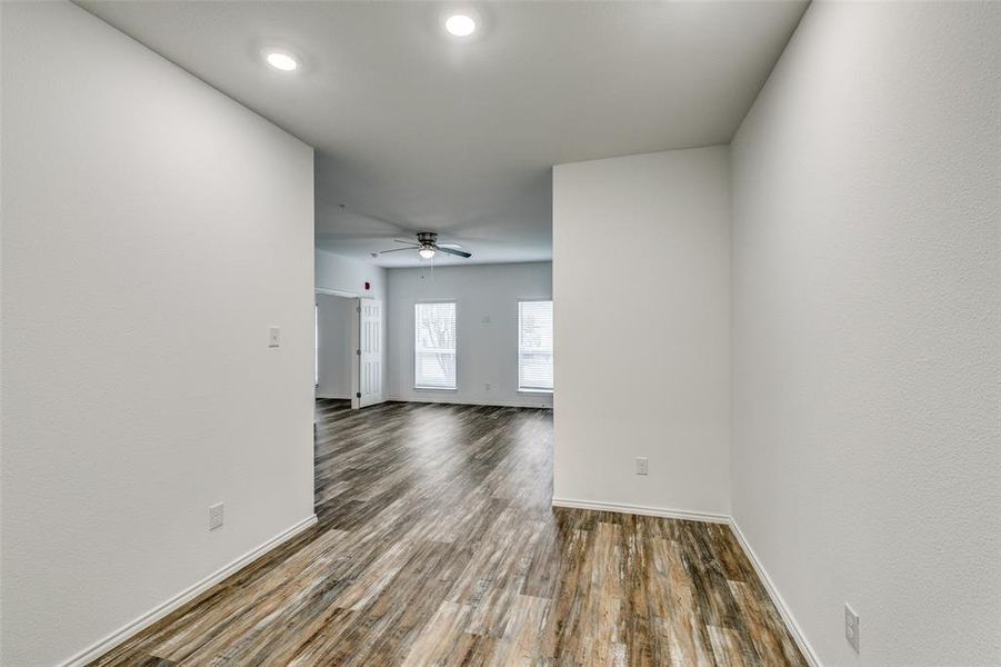 Spare room with dark hardwood / wood-style flooring and ceiling fan