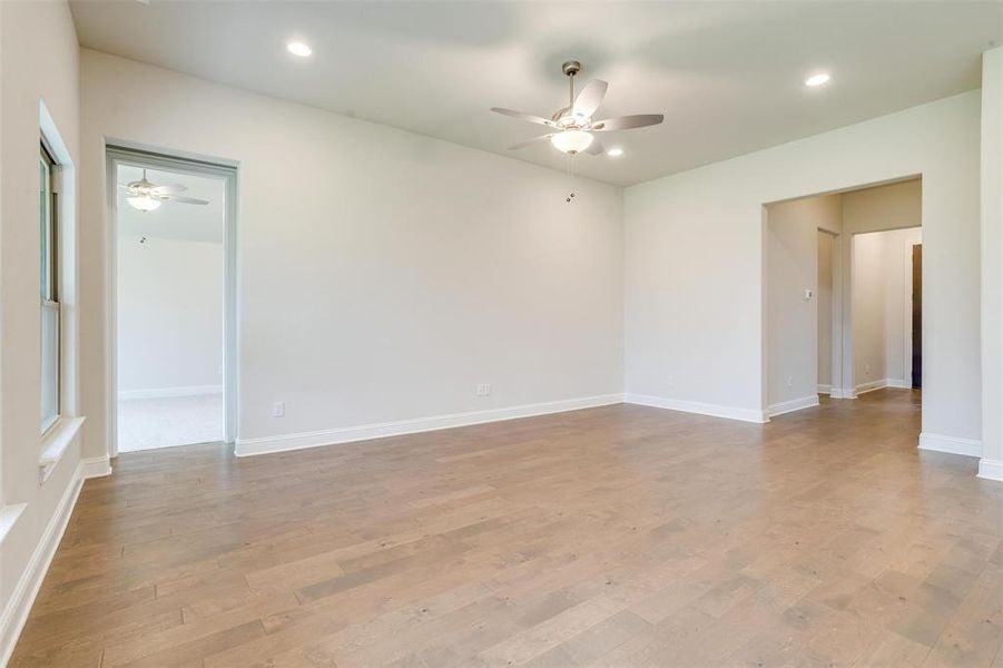 Unfurnished room with light hardwood / wood-style flooring and ceiling fan