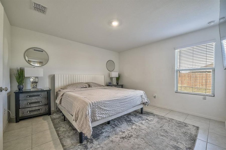 Bedroom with light tile patterned flooring