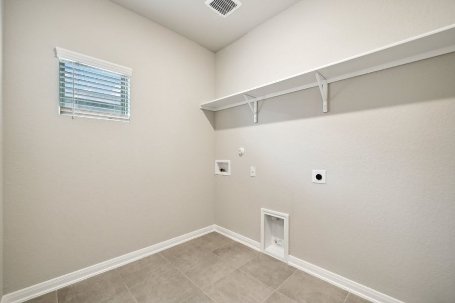 Laundry room in the Reynolds floorplan at a Meritage Homes community.