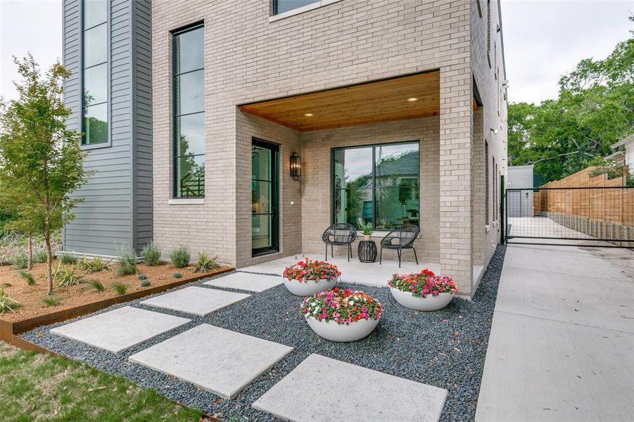 Inviting Front Porch with pavers and landscape pots with drip lines. Ample parking and privacy gate to back.