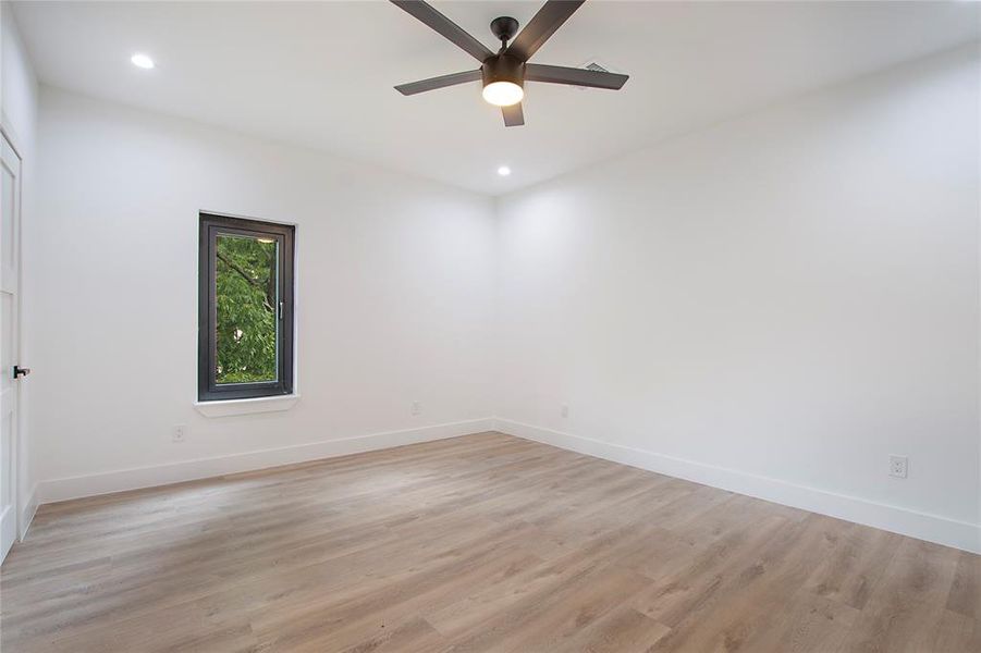 Unfurnished room with light wood-type flooring and ceiling fan