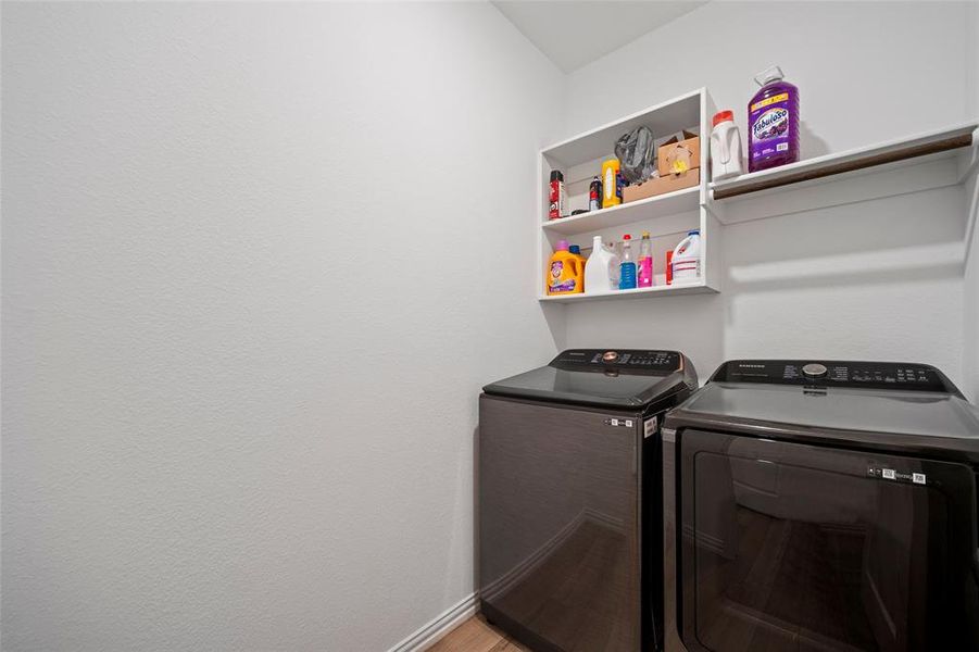 Laundry room with hardwood / wood-style floors and independent washer and dryer