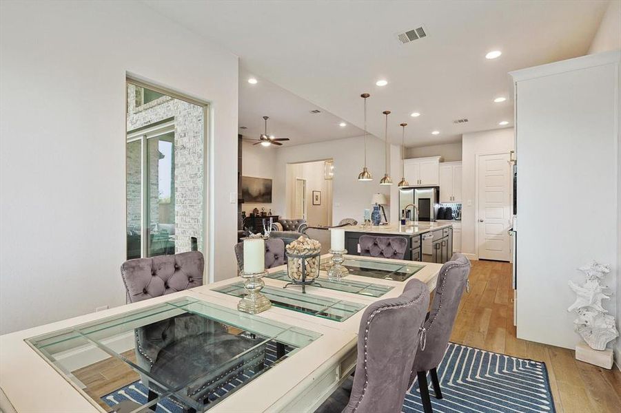 Dining area featuring light hardwood / wood-style flooring, sink, and ceiling fan