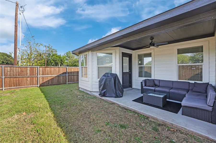 View of yard with outdoor lounge area, ceiling fan, and a patio