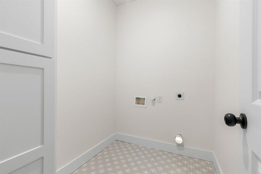 Washroom featuring washer hookup, hookup for an electric dryer, and light tile patterned floors